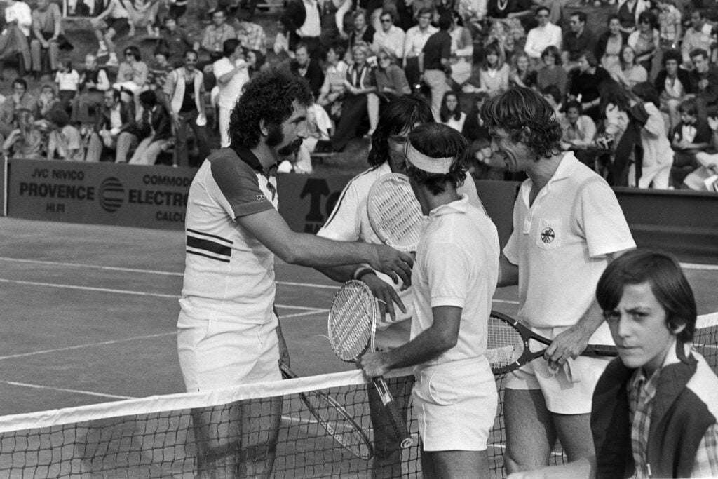 Ilie Nastase and Ion Tiriac playing doubles together in 1977
