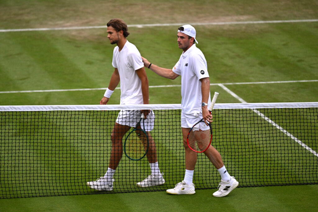 Otto Virtanen of Finland meets Tommy Paul of United States at the net following defeat in his Gentlemen's Singles second round match during day three of The Championships Wimbledon 2024 at All England Lawn Tennis and Croquet Club.