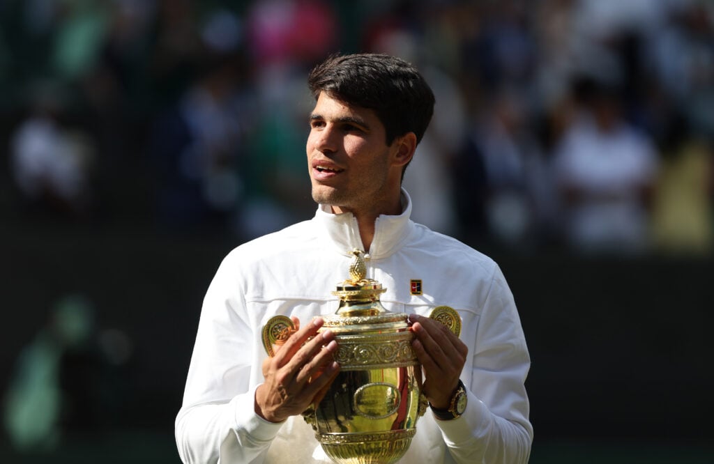 Carlos Alcaraz celebrates with the trophy after winning Wimbledon 2024