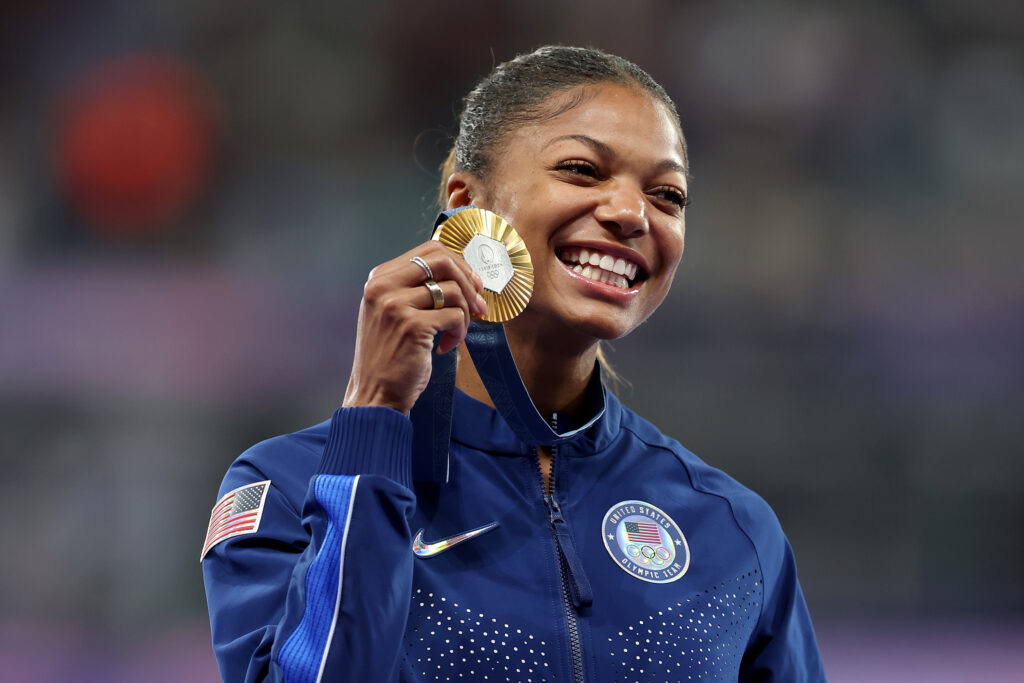 Gabby Thomas celebrates with her gold medal at the 2024 Paris Olympics
