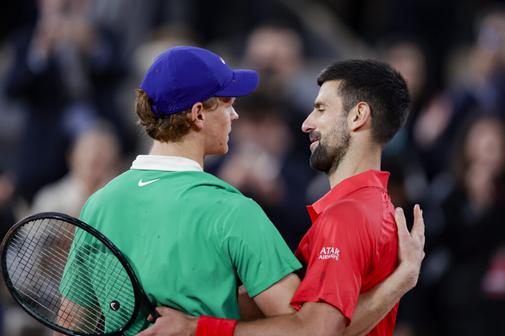 Jannik Sinner and Novak Djokovic embrace after their match at the 2025 French Open.