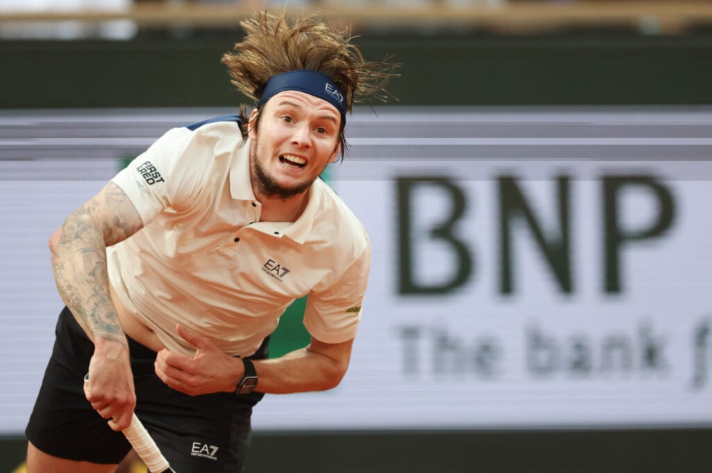 Alexander Bublik hits a serve at the 2025 French Open
