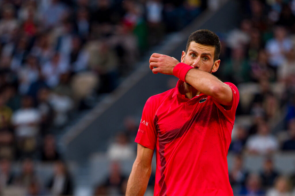 Novak Djokovic of Serbia reacts against Jannik Sinner of Italy during the Men's Singles Semi Final match on Day Thirteen of the 2025 French Open at Roland Garros.