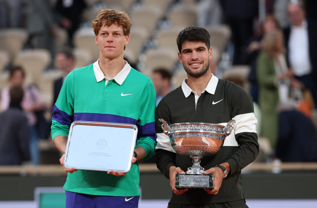 Carlos Alcaraz of Spain poses for a photo with the Coupe des Mousquetaires trophy alongside runner-up Jannik Sinner of Italy following his victory in the Men’s Singles Final match on Day Fifteen of the 2025 French Open at Roland Garros.