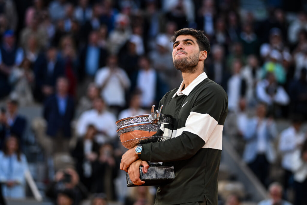 Carlos Alcaraz of Spain holds the Coupe des Mousquetaires trophy following his victory over Jannik Sinner of Italy in the Men's Singles Final match on Day Fifteen of the 2025 French Open at Roland Garros.