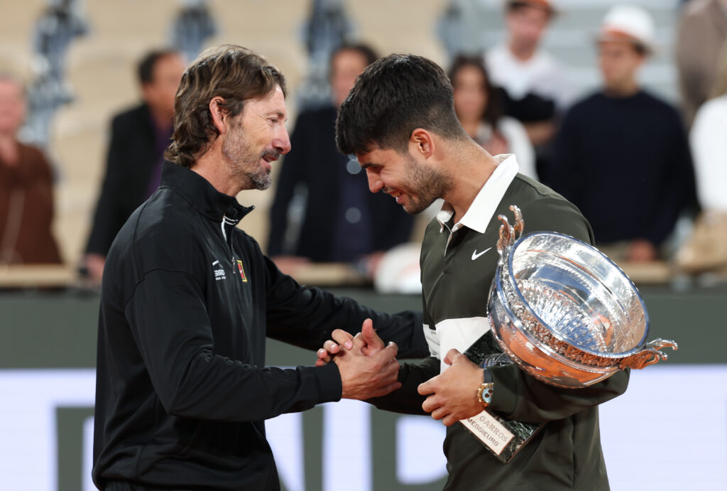 Carlos Alcaraz and Juan Carlos Ferrero embrace after winning the 2025 French Open