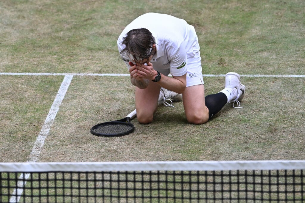 Alexander Bublik falls to his knees after winning the Halle Open.