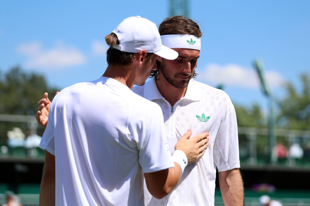 Stefanos Tsitsipas and Valentin Royer at the net after their match at Wimbledon.