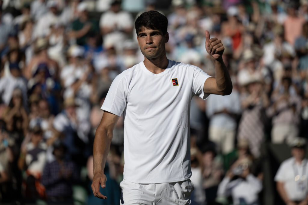 Carlos Alcaraz of Spain acknowledges the crowd following his victory against Fabio Fognini of Italy in their Gentlemen's Singles first round match on day one of The Championships Wimbledon 2025.