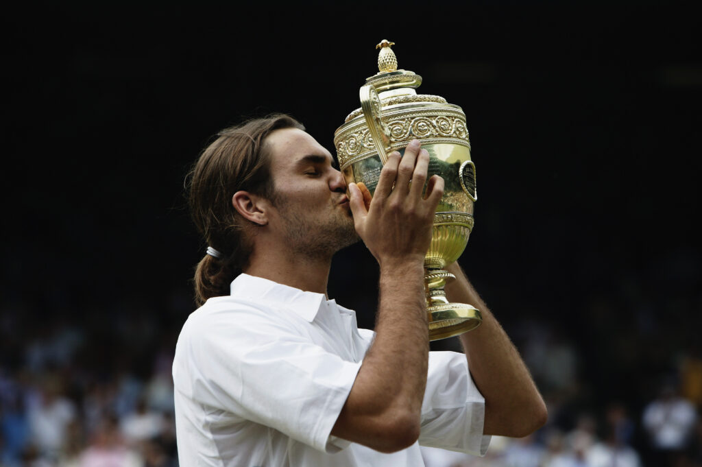 Roger Federer of Switzerland kisses the Wimbledon trophy in 2003.