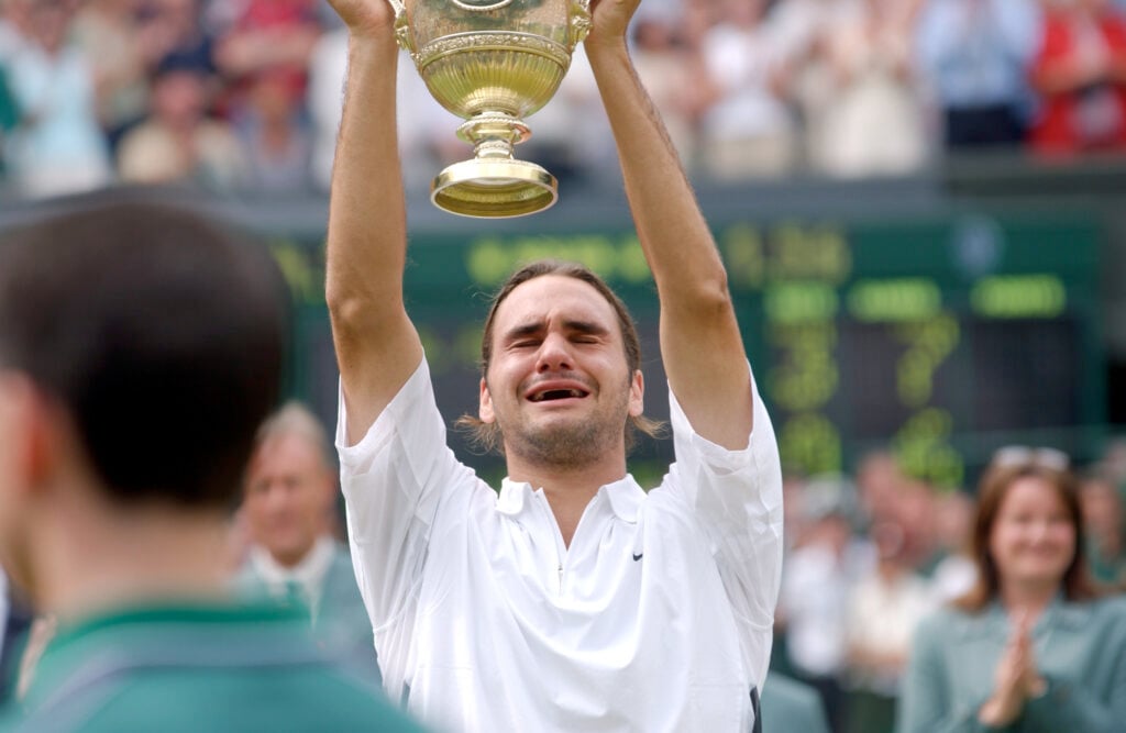 Roger Federer of Switzerland holds the trophy after his victory over Mark Philippoussis of Australia in the Mens Singles Final during the final day of the Wimbledon Lawn Tennis Championships held on July 6, 2003.