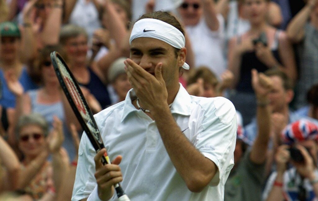 Roger Federer celebrates after winning his fourth round match against US player Pete Sampras at the All England Tennis Championships in Wimbledon.
