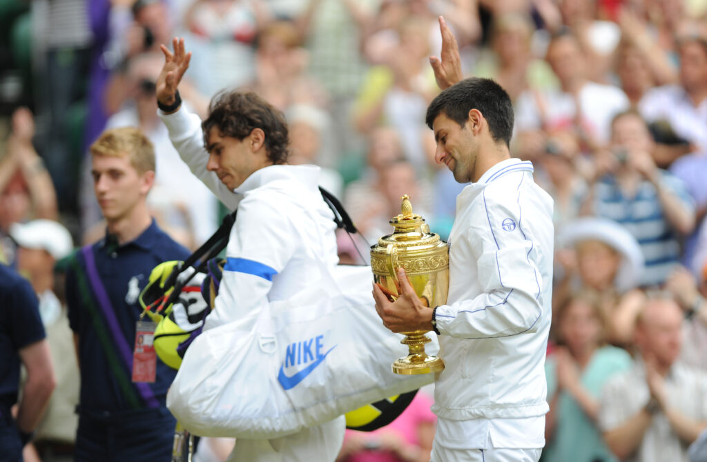Novak Djokovic and Rafael Nadal waving to the crowd at Wimbledon in 2011.