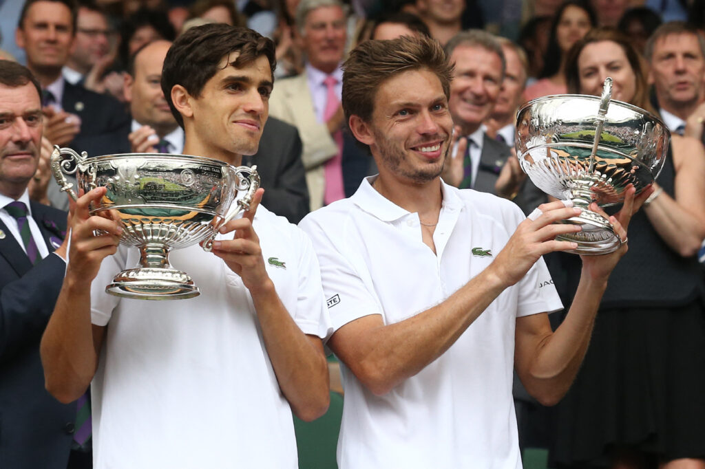 Pierre-Hugues Herbert and Nicolas Mahut pose with the Wimbledon title in 2016