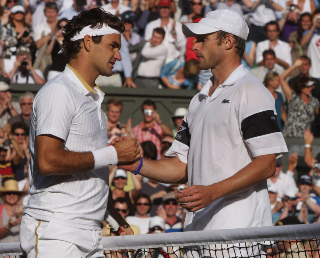 Roger Federer and Andy Roddick meet at the net at Wimbledon in 2009.