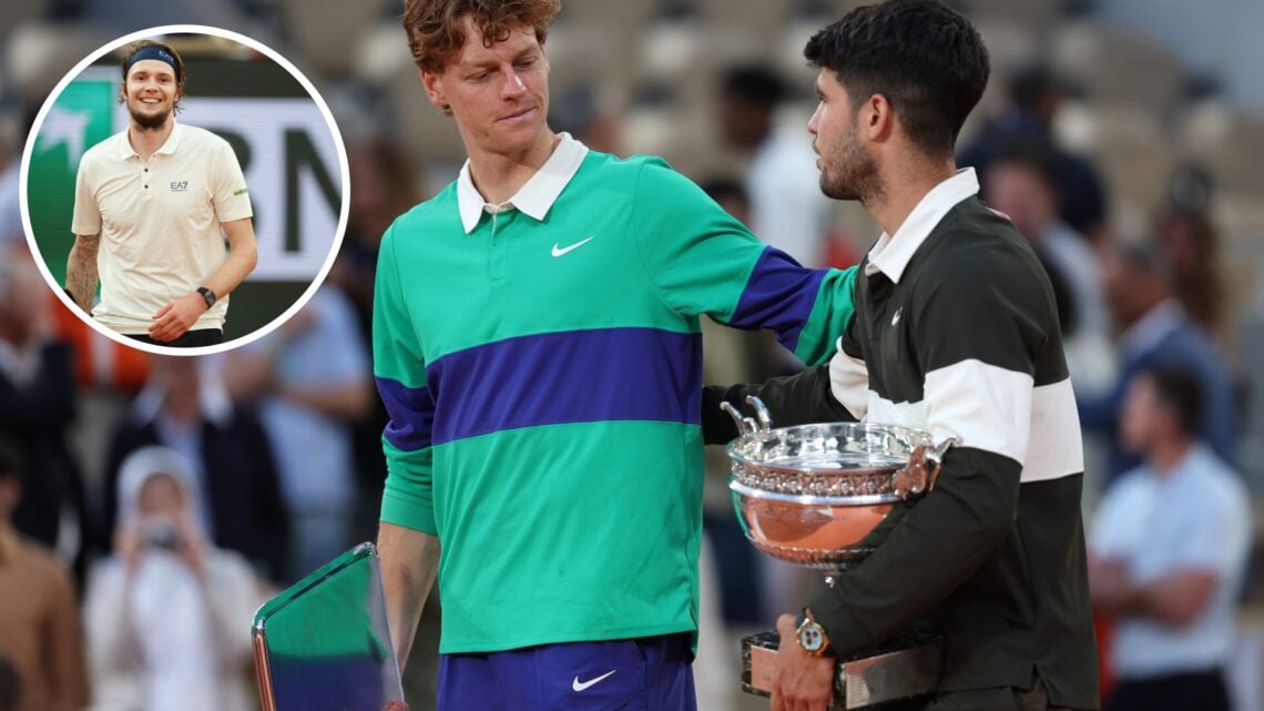 Carlos Alcaraz of Spain holds the Coupe des Mousquetaires trophy as he speaks with runner-up Jannik Sinner of Italy following his victory in the Me...