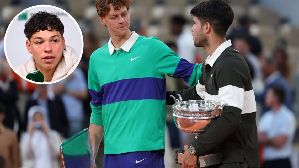 Carlos Alcaraz of Spain holds the Coupe des Mousquetaires trophy as he speaks with runner-up Jannik Sinner of Italy following his victory in the Me...