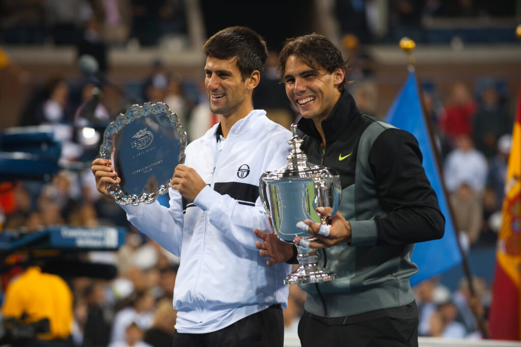 Novak Djokovic and Rafael Nadal pose with their trophies after the 2010 US Open final