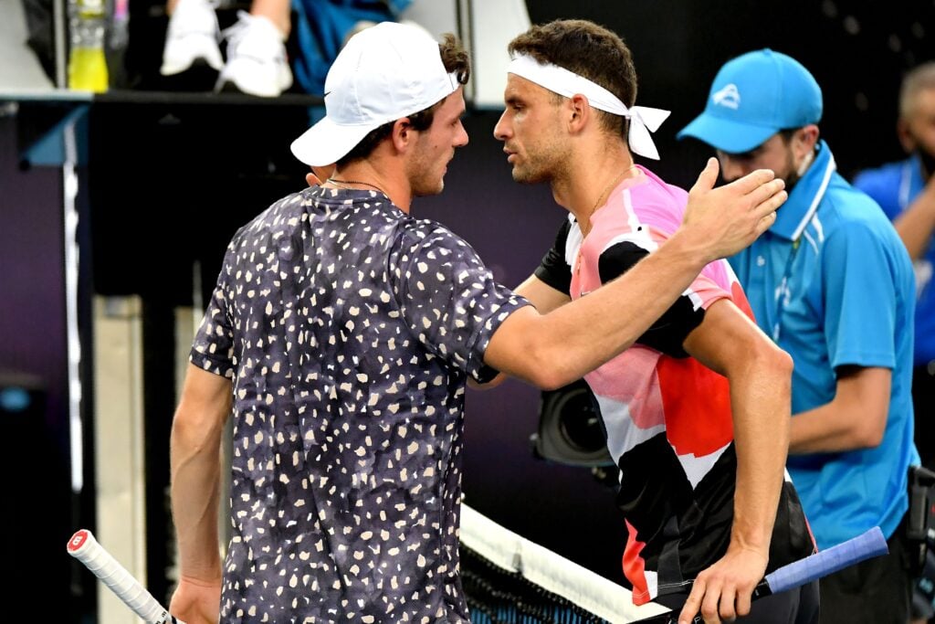 Grigor Dimitrov and Tommy Paul embrace after their match at the 2020 Australian Open