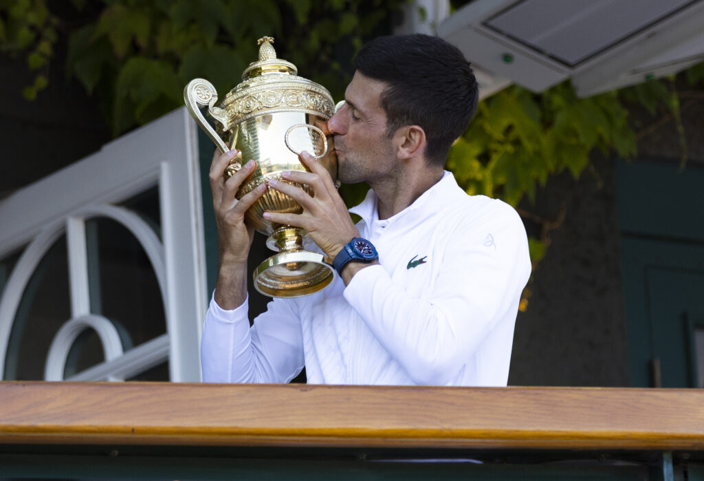 Novak Djokovic kisses the Wimbledon trophy