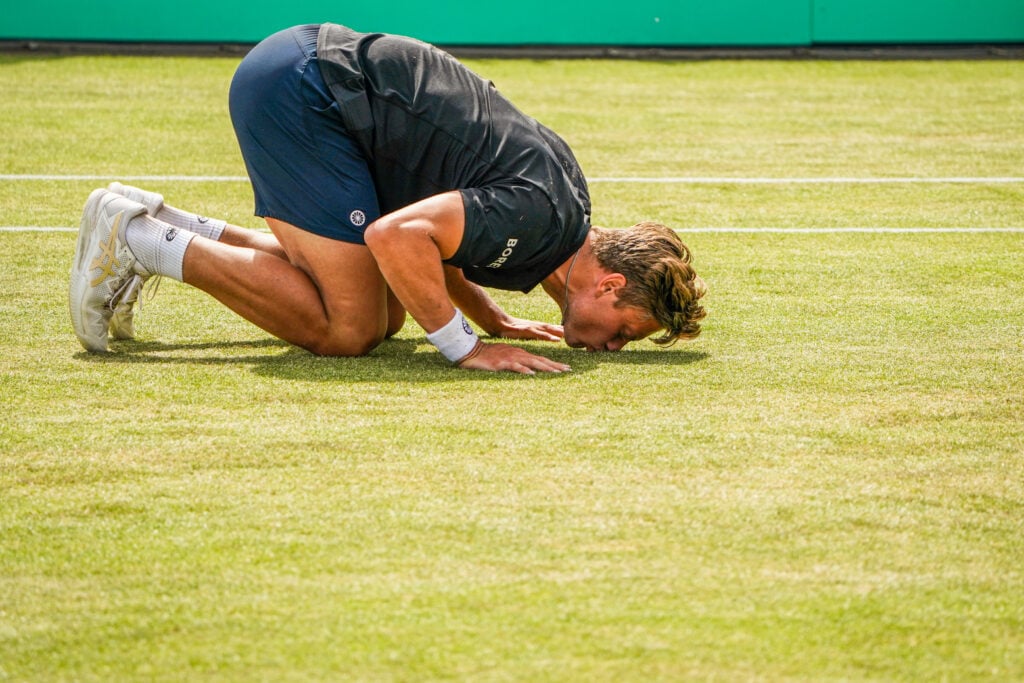 Tim van Rijthoven of the Netherlands kisses the grass after the Mens Singles Final match between Daniil Medvedev of Russia and Tim van Rijthoven of the Netherlands at the Autotron on June 12, 2022 in 's-Hertogenbosch.