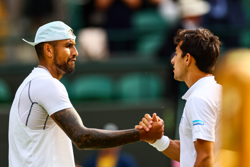 Nick Kyrgios and Cristian Garin embrace after their match at Wimbledon in 2022