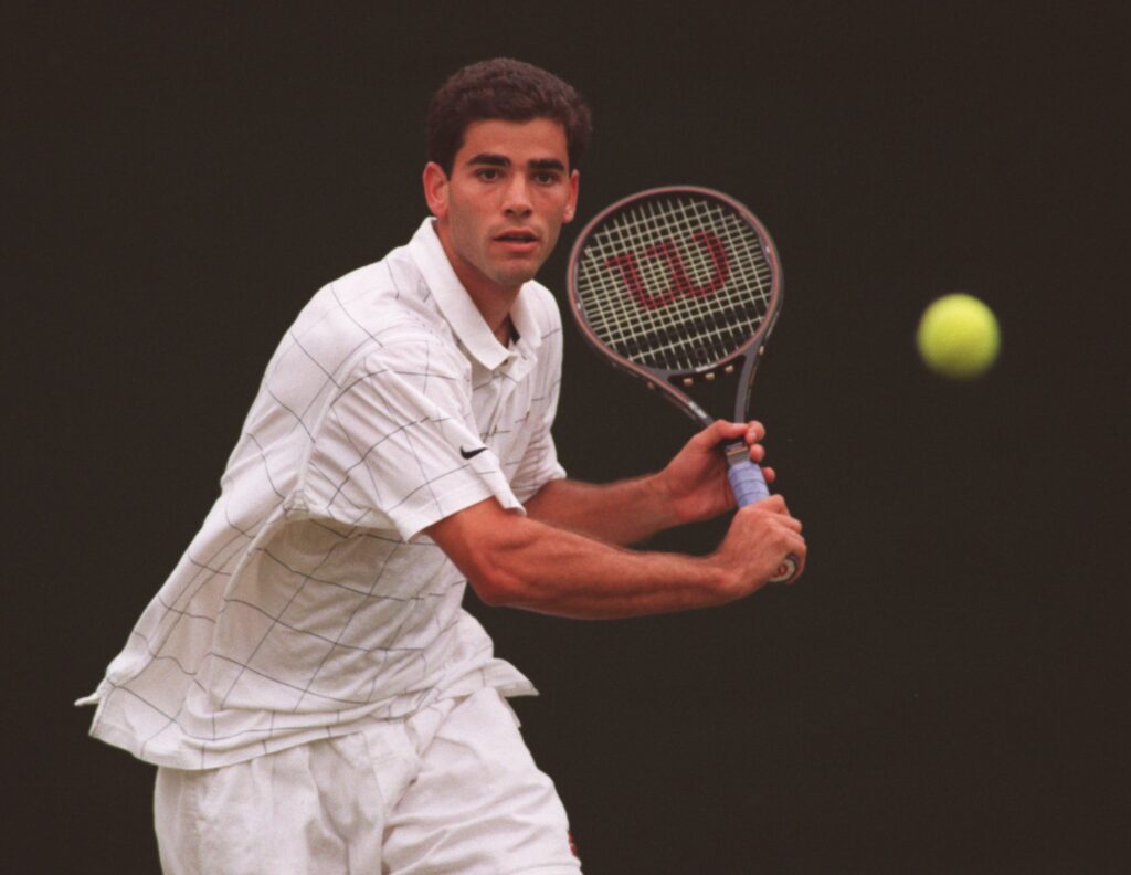 Pete Sampras focuses on the ball as he prepares to hit a return against Greg Rusedski at Wimbledon in 1995.