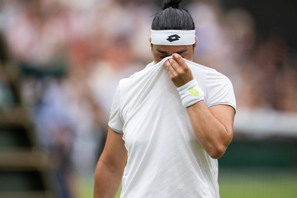 Ons Jabeur covers her face to hide tears