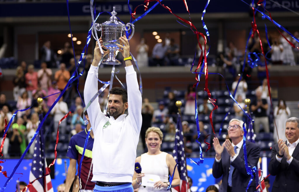 Novak Djokovic hoisting the 2023 US Open title.