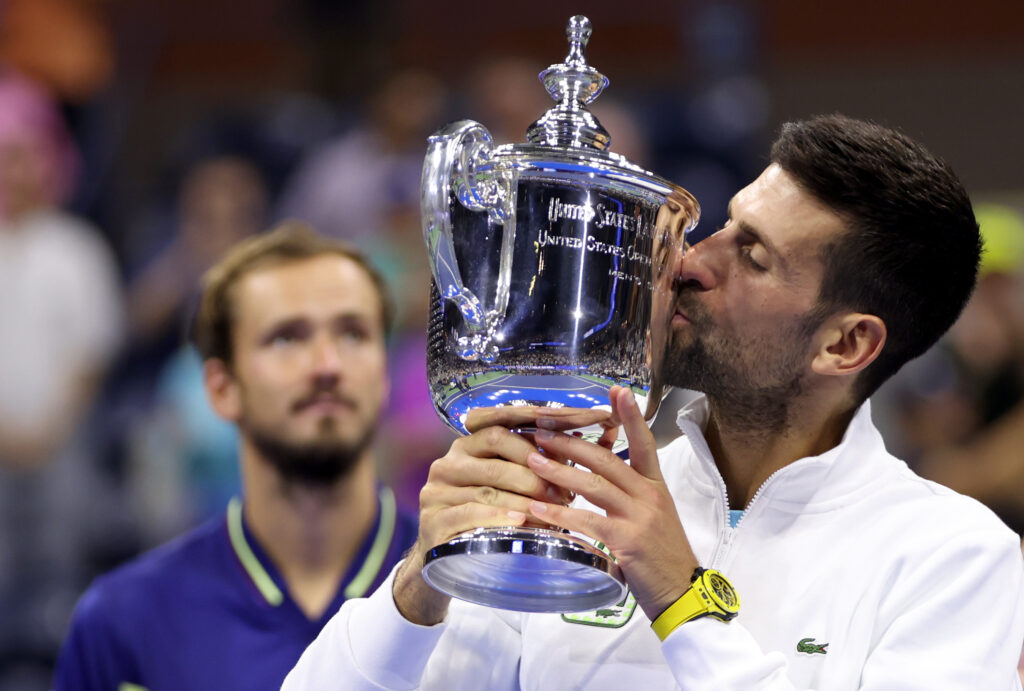 Novak Djokovic kissing the 2023 US Open title.