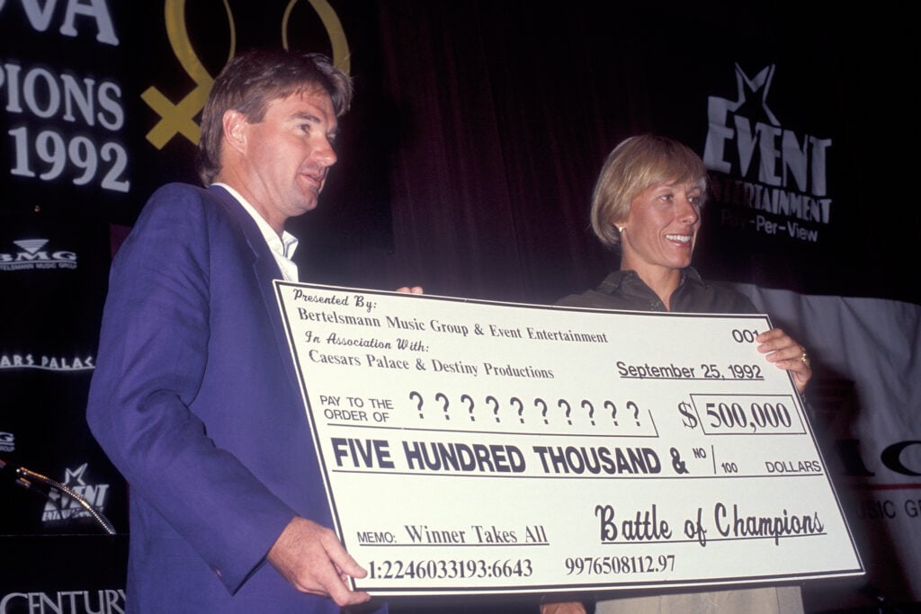 Jimmy Connors and Martina Navratilova pose with the cheque ahead of the 'Battle of Champions'