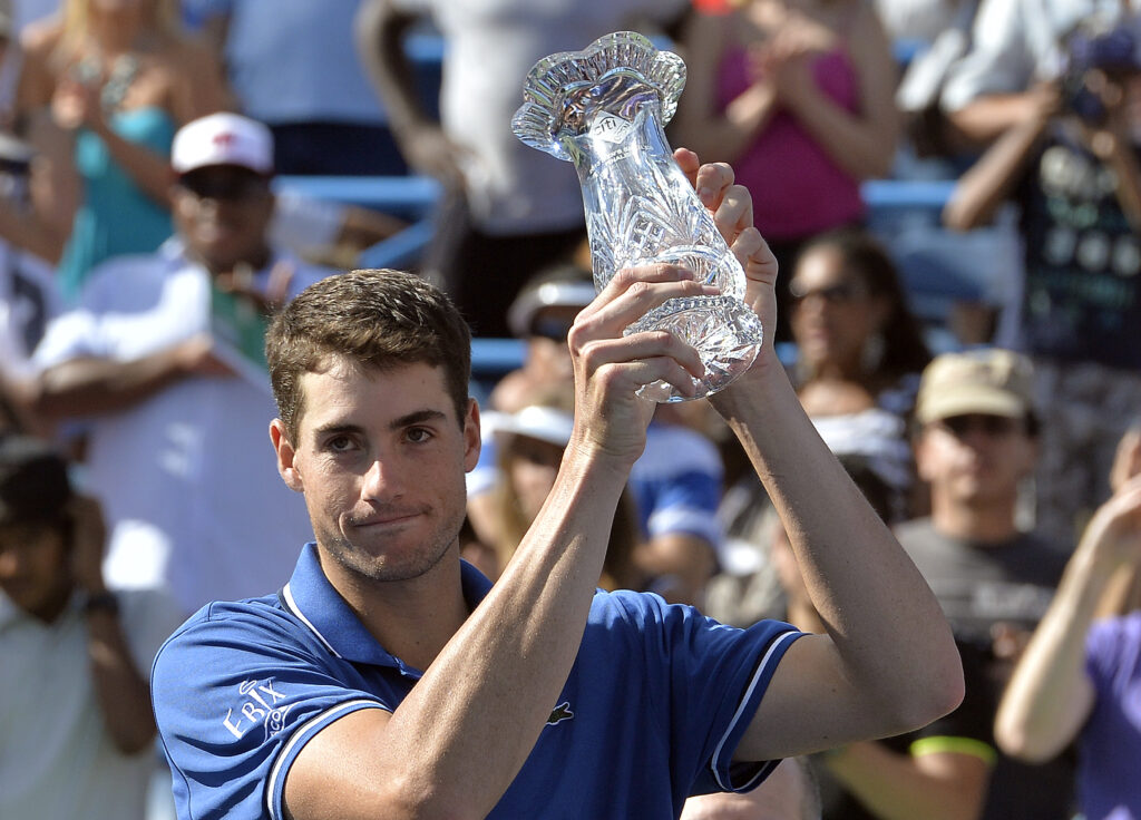 John Isner holds up the runner-up trophy at the 2013 Citi Open