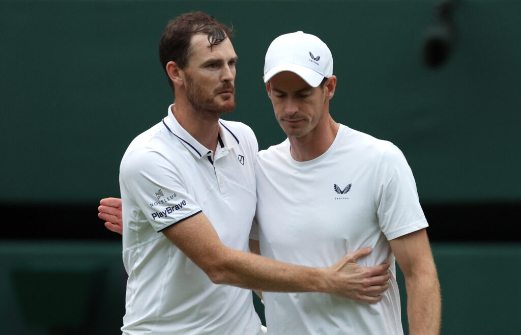 Jamie Murray and Andy Murray embrace after their defeat at Wimbledon in 2024