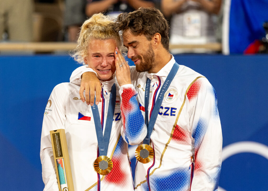 Gold medalists Katerina Siniakova and Tomas Machac of Team Czechia pose for a photo on the podium during the Tennis Mixed Doubles medal ceremony on day seven of the Olympic Games Paris 2024 at Roland Garros.