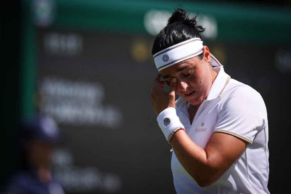 Ons Jabeur reacts during her first-round defeat at Wimbledon in 2025