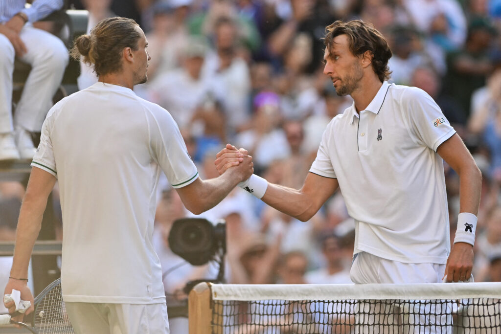 Alexander Zverev and Arthur Rinderknech shake hands after their match at Wimbledon in 2025