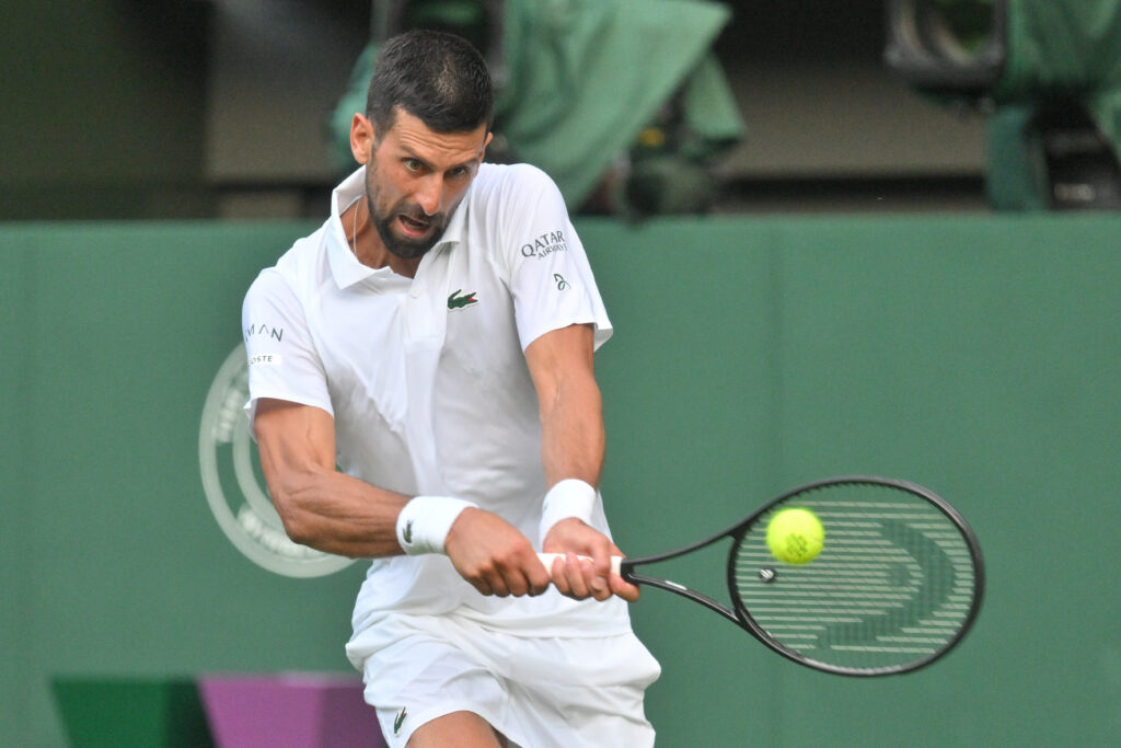 Novak Djokovic hits a backhand at Wimbledon