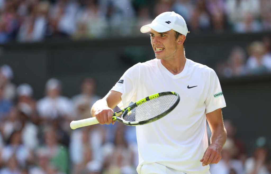 Oliver Tarvet in action against Carlos Alcaraz at Wimbledon in 2025