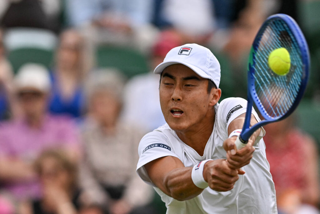 Rinky Hijikata in action against Ben Shelton at Wimbledon in 2025