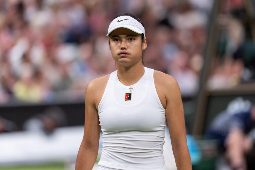 Emma Raducanu looks on during her defeat to Aryna Sabalenka at Wimbledon in 2025