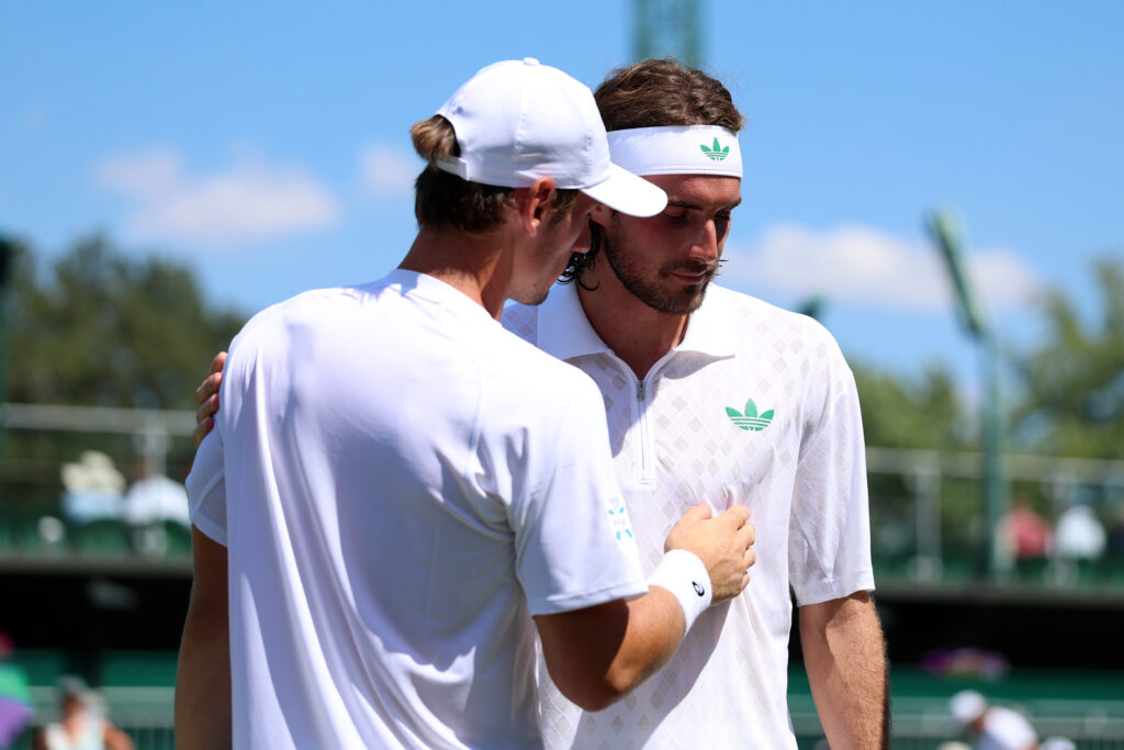 Stefanos Tsitsipas and Valentin Royer embrace at the net after their Wimbledon first-round match