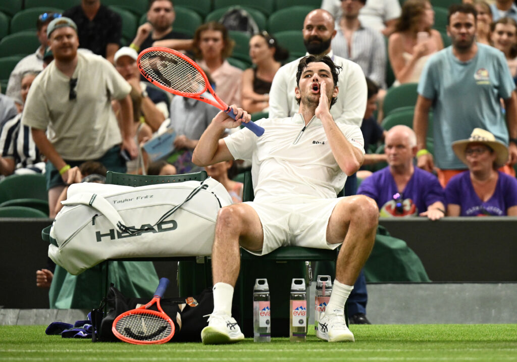 Taylor Fritz shouts whilst sat at a changeover