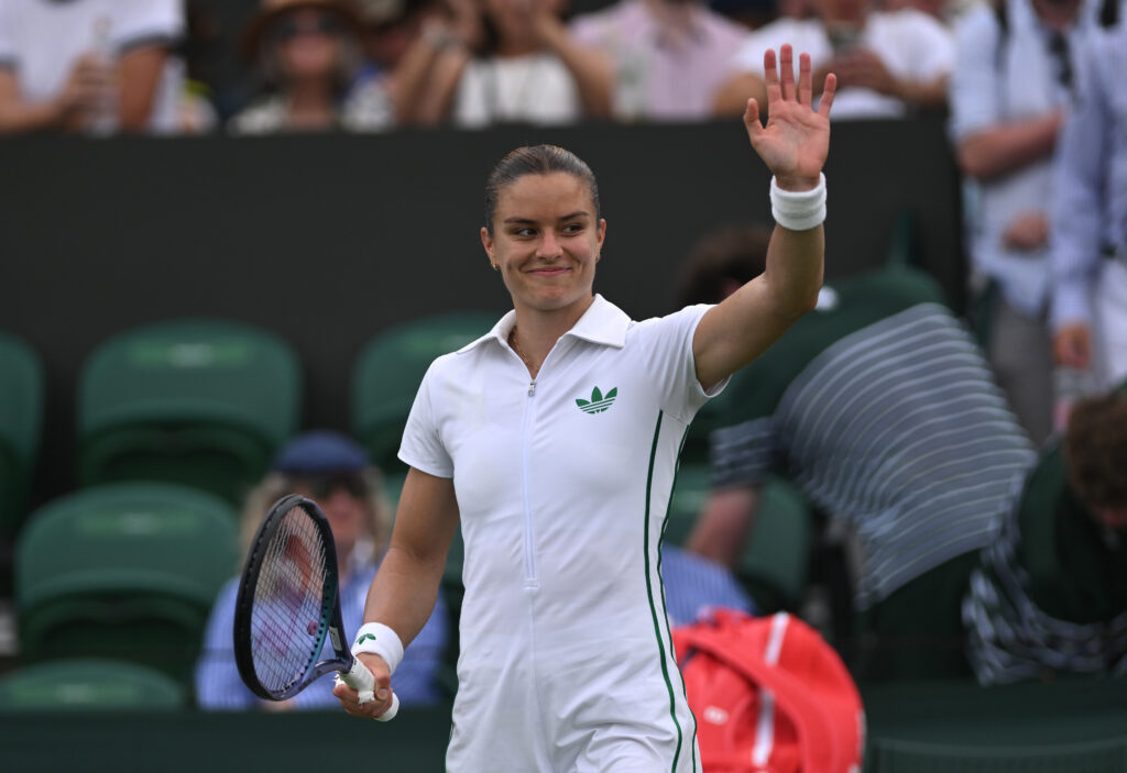 Maria Sakkari of Greece acknowledges the crowd as she celebrates following her victory against Anna Blinkova during the Ladies' Singles first round match on day two of The Championships Wimbledon 2025 at All England Lawn Tennis and Croquet Club.