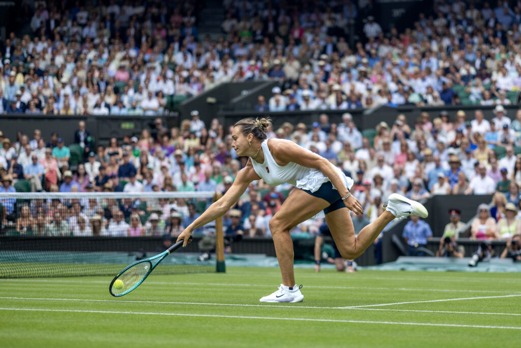 Aryna Sabalenka stretches to hit a shot