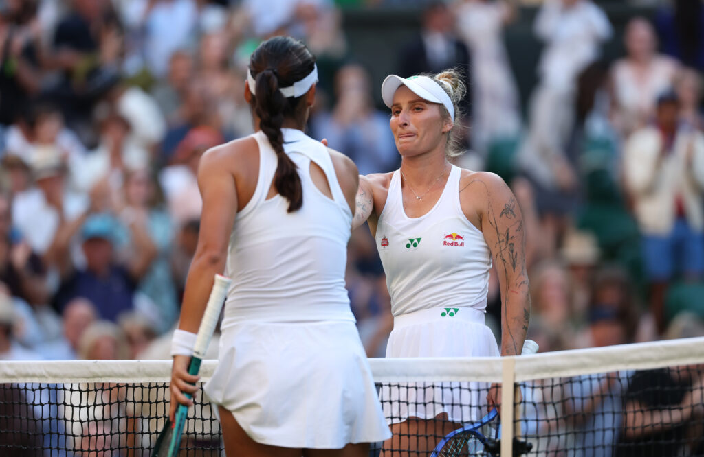 Emma Raducanu and Marketa Vondrousova shake hands at the net after their match at Wimbledon in 2025
