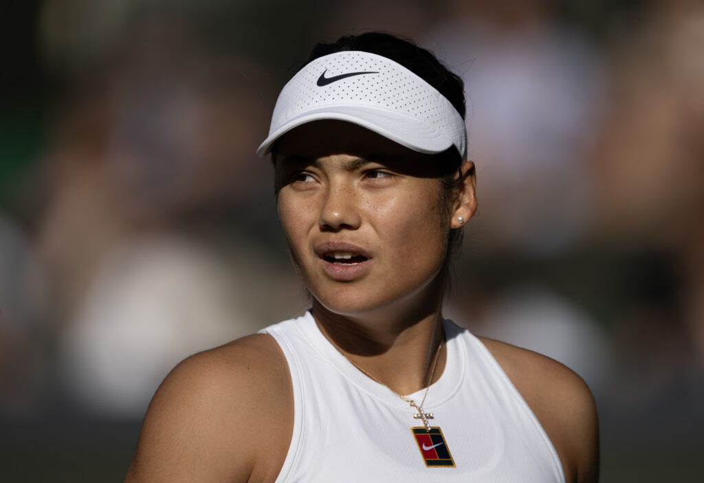 Emma Raducanu of Great Britain looks on against Marketa Vondrousova of Czechia during the Ladies' Singles second round match on day three of The Championships Wimbledon 2025 at All England Lawn Tennis and Croquet Club.