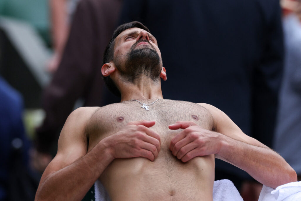 Novak Djokovic, shirtless, breaths in
