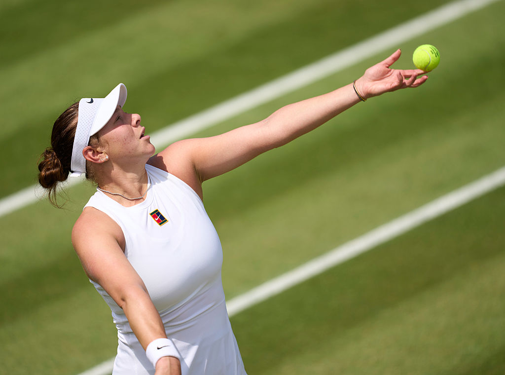 Amanda Anisimova serves at the 2025 Wimbledon Championships