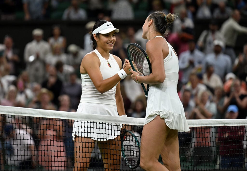 Emma Raducanu and Aryna Sabalenka shake hands at the net after their match at Wimbledon in 2025