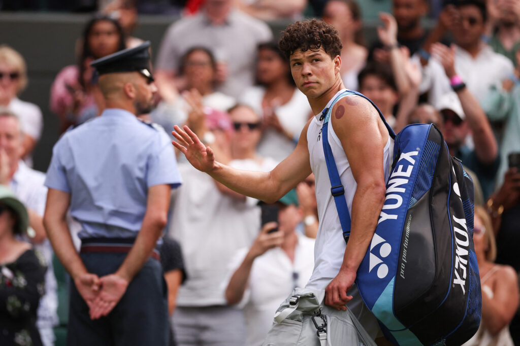 Ben Shelton reacts as he leaves Court 1 following his defeat against Italy's Jannik Sinner during their men's singles quarter-final tennis match on the tenth day of the 2025 Wimbledon Championships at The All England Lawn Tennis and Croquet Club.